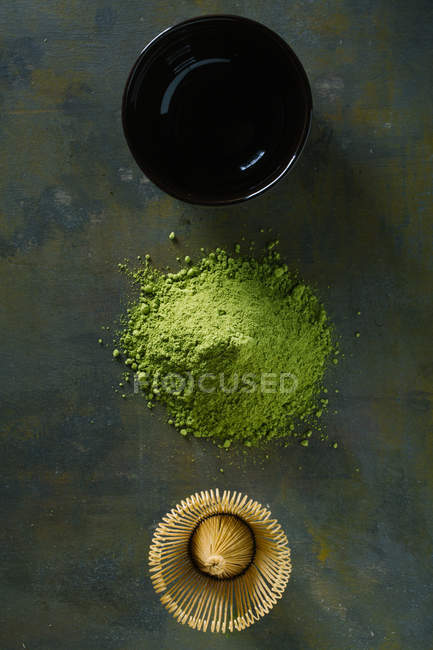 Pile of matcha tea with bamboo whisk and cup in row — Stock Photo