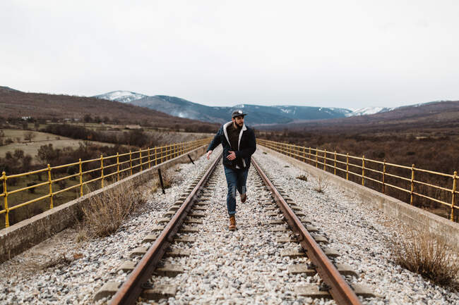 Man running on railroad RELEASE — Stock Photo