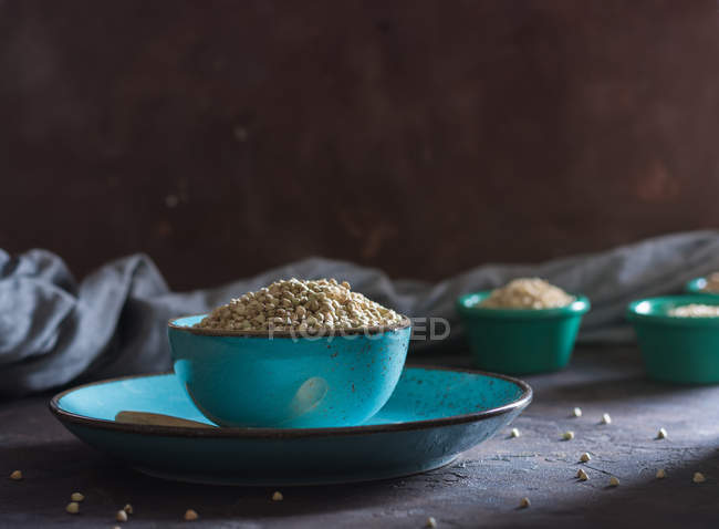 Bowl filled with buckwheat and other cereals wheat flakes. — Stock Photo