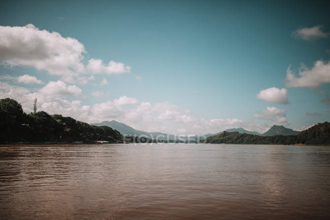 Landscape of dirty lake under scenic cloudscape — Stock Photo