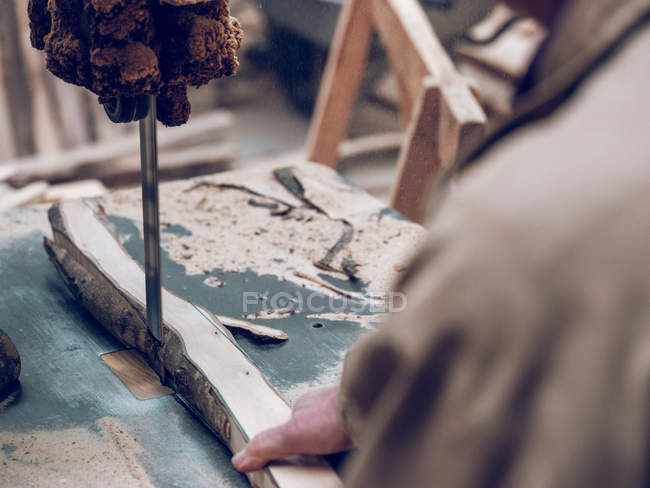 Over shoulder view of artisan working with wood — Stock Photo
