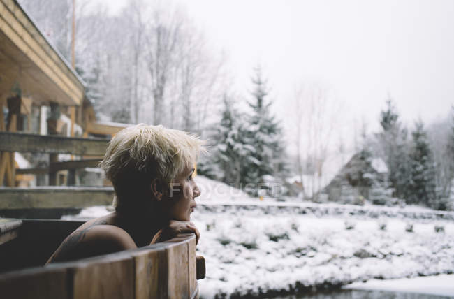 Portrait of blonde woman relaxing in plunge tub in winter outdoor — Stock Photo