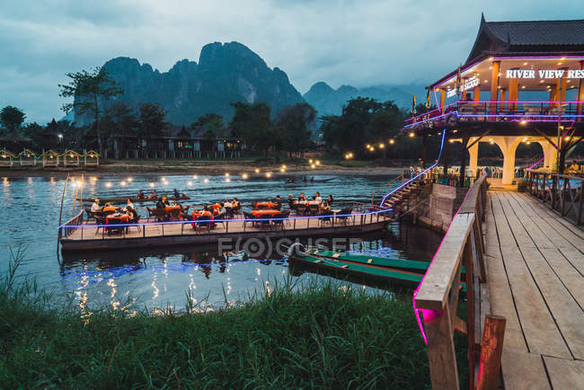 Beautiful terrace of restaurant floating on river. — Stock Photo