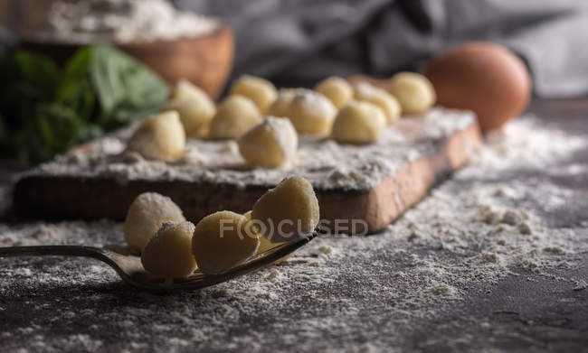 Close up view of raw gnocchi on fork at table — Stock Photo