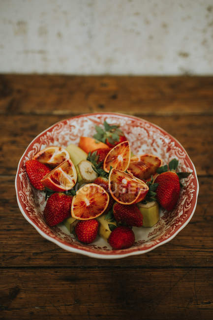 Ciotola con diverse fette di frutta fresca — Foto stock