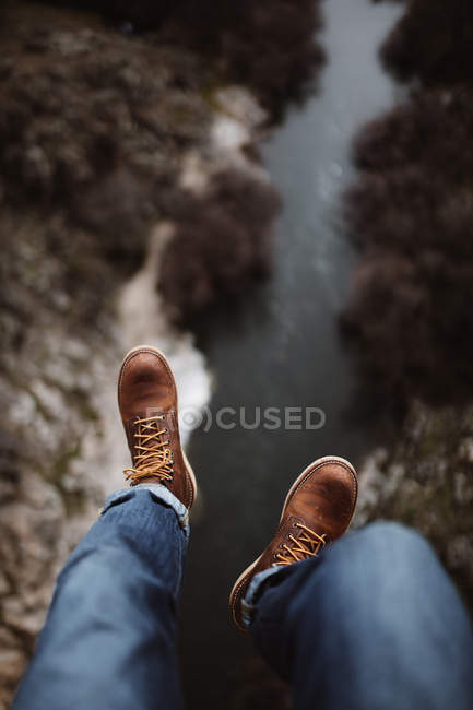 Looking down view of legs of tourist against meadow — Stock Photo