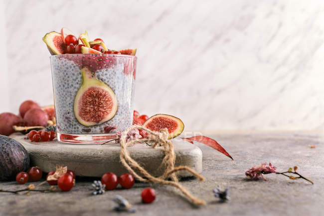 Glass of delicious chia smoothie with coconut milk on stone board — Stock Photo