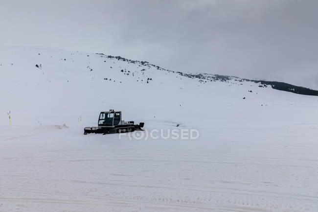 Side view of snow removal machine at winter field — Stock Photo