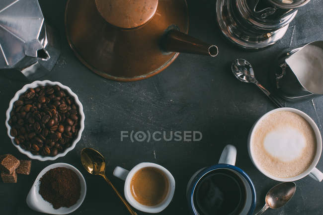 Different types of coffee and coffee makers on dark background — Stock Photo