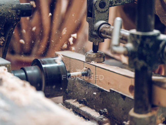 Piece of lumber cutting with professional carpentry machine in workshop. — Stock Photo