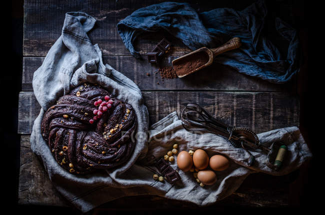 Still life of chocolate cake on rural table — Stock Photo