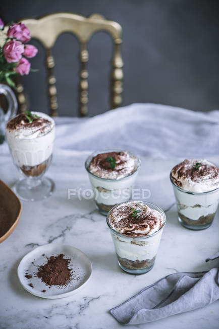 Sweet panna cota desserts in glasses on table — Stock Photo