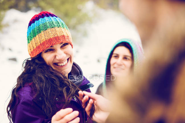 Friends having time outdoor in winter woods — Stock Photo