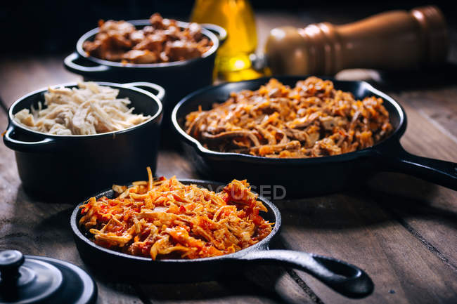 Still life of various dishes in frying pans — Stock Photo