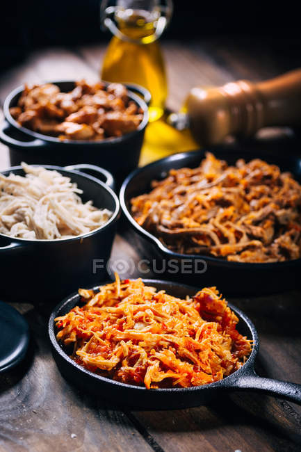 Bodegón de deliciosos platos en sartenes - foto de stock
