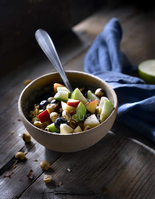 Still life of oatmeal with fresh fruit mix in bowl — Stock Photo