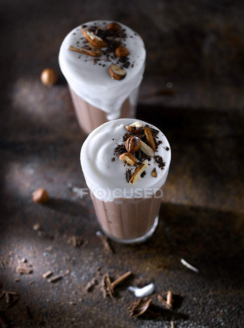 Glasses of sweet chocolate smoothie with ice-cream on table — Stock Photo