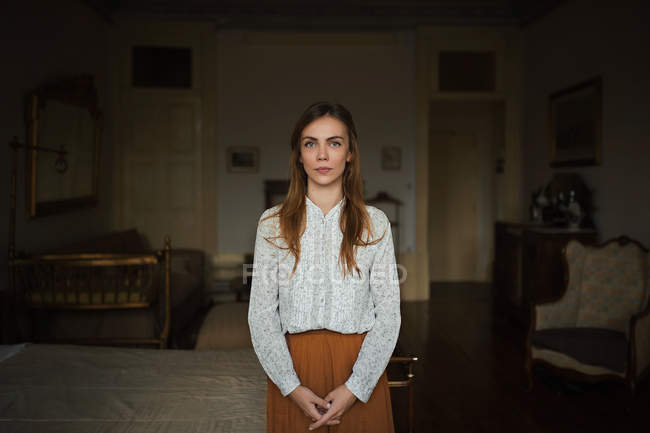 Young woman standing in bed room and looking at camera — Stock Photo