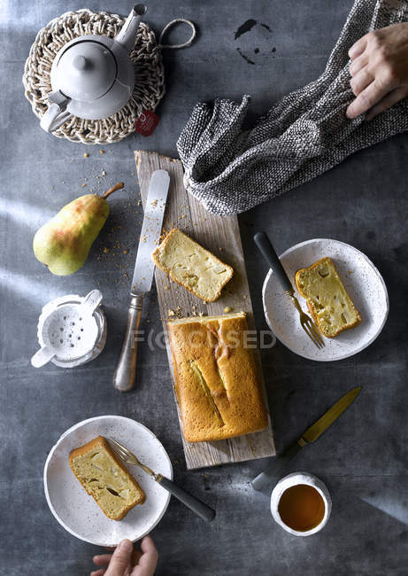 Directly above of freshly baked pear cake with tea on rustic table. — Stock Photo