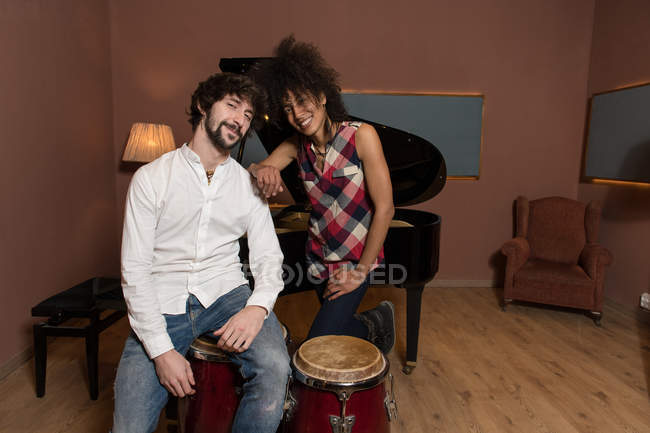 Man and woman sitting in recording studio — Stock Photo