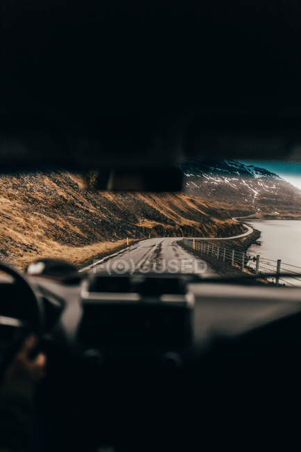 Long road alongside gray sea — Stock Photo