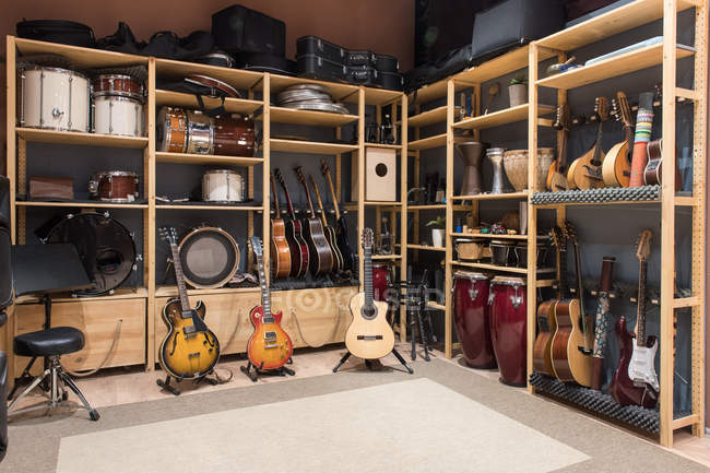 Shelves with musical instruments — Stock Photo