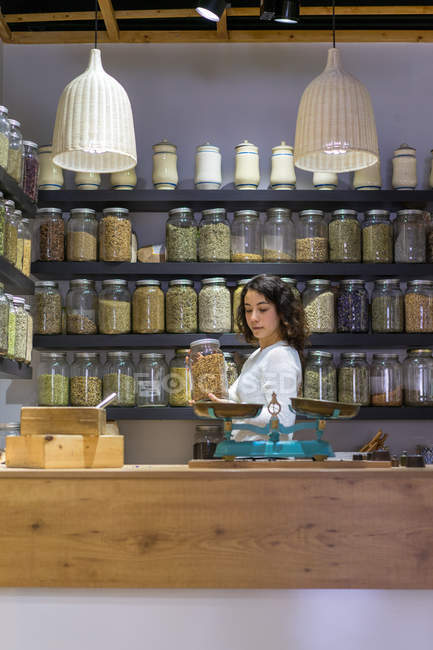 Mujer tomando tarro con especias - foto de stock