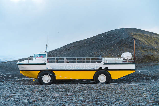 Лодка с колесами, стоящими на каменистом холме — стоковое фото