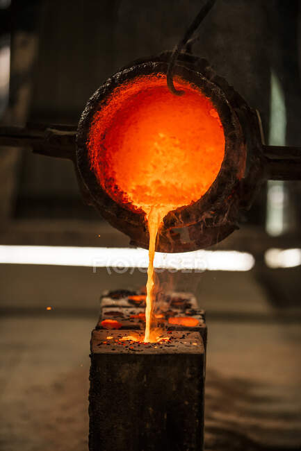 Hot molten metal pouring into casting mold in factory — Stock Photo