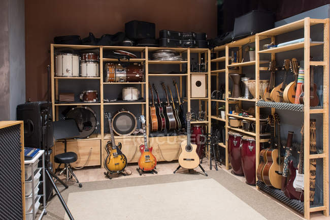 Shelf with drums and guitars — Stock Photo