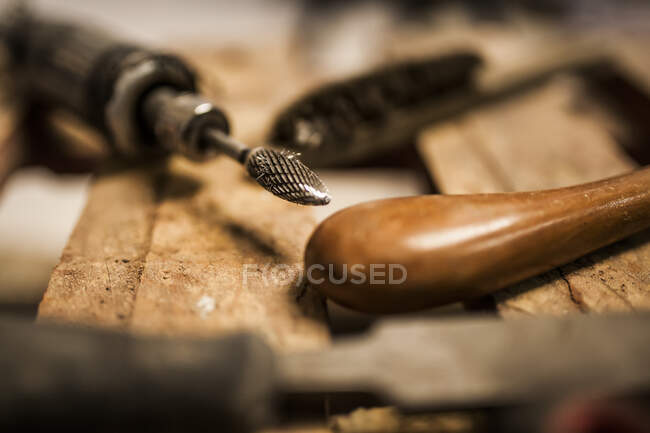 Crop close-up view of instruments for working with metal on wooden table — Stock Photo