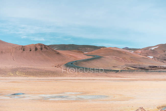 Barren plains and mountains with road — Stock Photo
