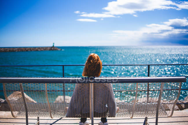 Redheaded woman relaxing at seaside — Stock Photo