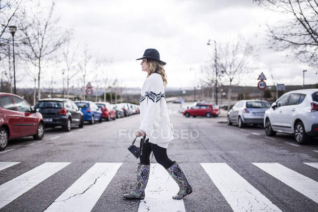 Femme sur le passage à niveau traversant la route sur zèbre — Photo de stock