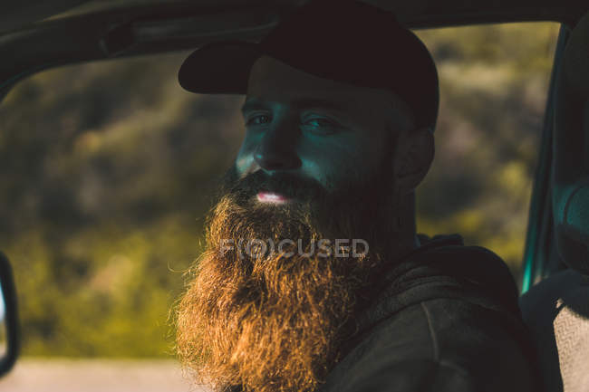 Bearded man sitting in car — Stock Photo