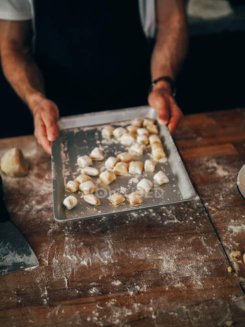Hands holding dough pieces — Stock Photo
