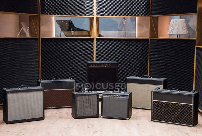 Set of amplifiers near piano — Stock Photo