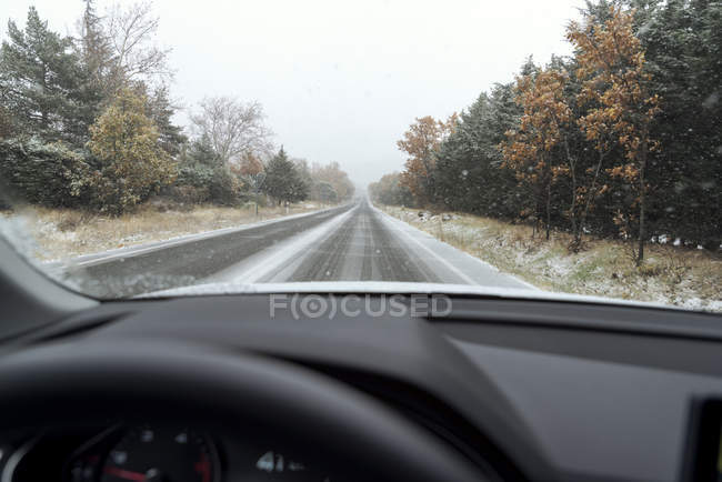 Driving car on snowy road — Stock Photo