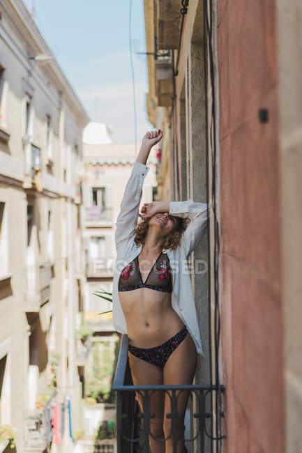 Woman in stylish underwear on balcony — Stock Photo