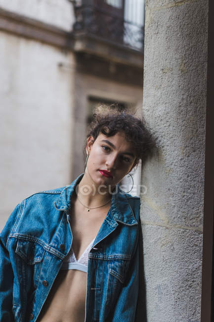 Woman in lingerie and denim jacket on balcony — Stock Photo