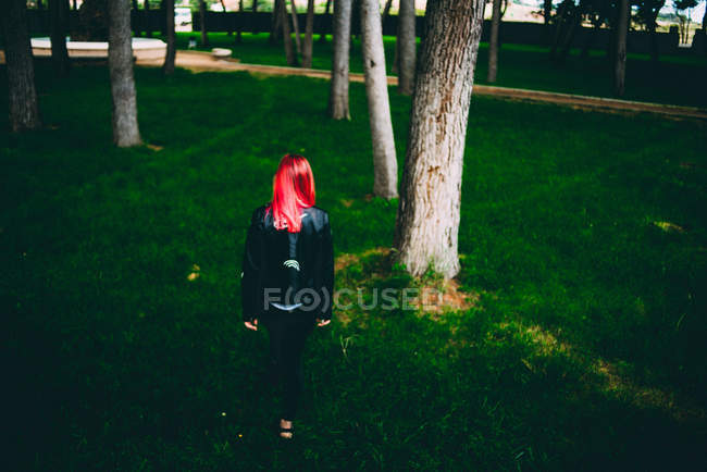 Stylish woman walking on grass — Stock Photo