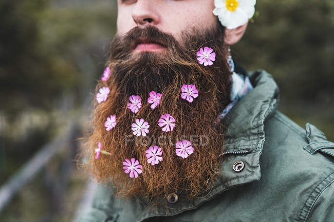 Man with flowers in beard — Stock Photo