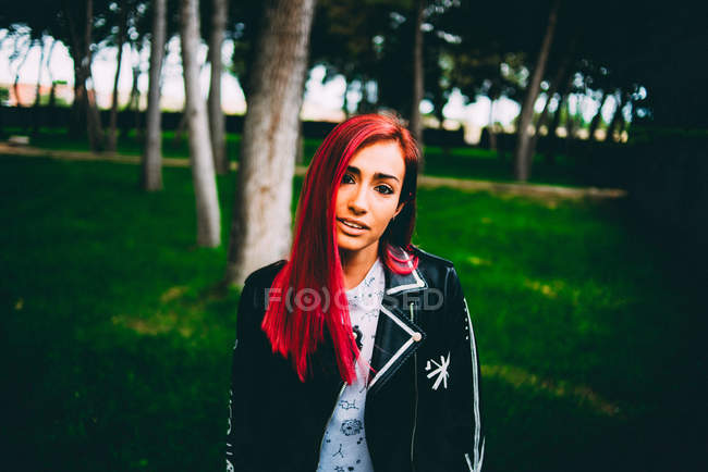 Стильная женщина с рыжими волосами на траве — стоковое фото