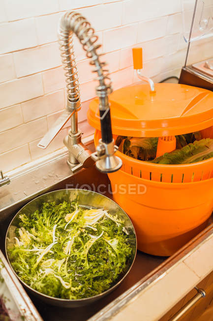 Green lettuce prepared for washing — Stock Photo