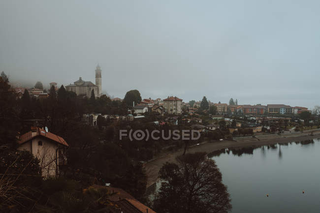 Town with bare trees and pond — Stock Photo
