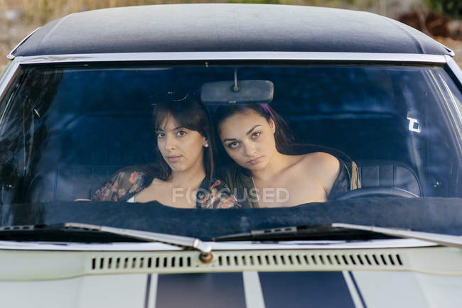 Mujeres sentadas en coche - foto de stock