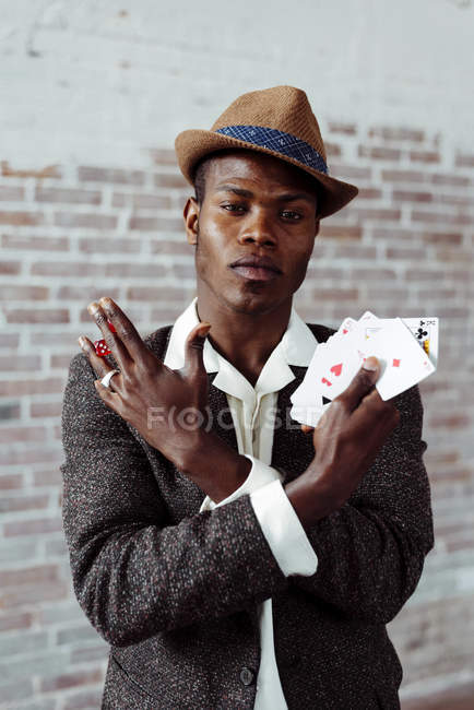 Man showing cards and dices — Stock Photo