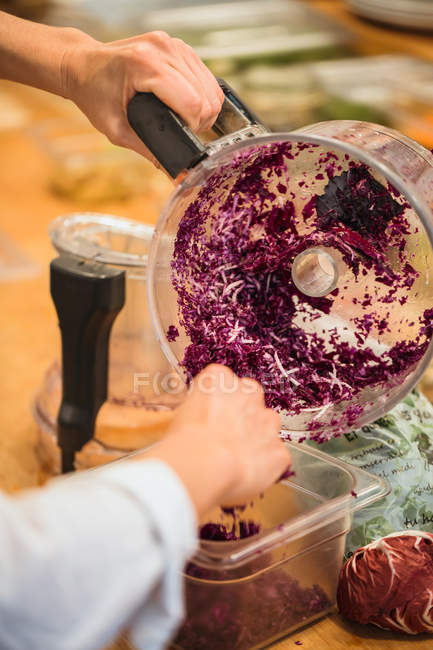 Hands putting cabbage to container — Stock Photo