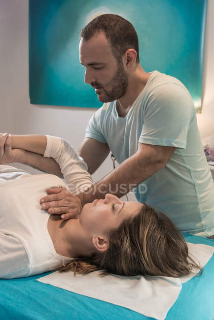 Терапевт проводит альтернативную терапию тела для стимуляции тканей тела в массажном кабинете — стоковое фото