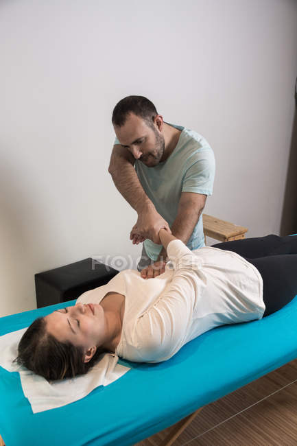 Terapeuta haciendo terapia alternativa tratamiento corporal para estimular los tejidos corporales en la sala de masajes - foto de stock